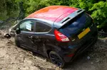Abandoned Black Car on Dirt Road
